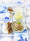 Matjes herring tartare with diced melon, nut bread & lukewarm cucumber soup