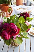 Vase of roses on laid table