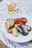 Sardines with tomatoes, bread and lemon