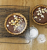 Warm chocolate tarts with macadamia nuts