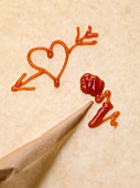 Heart with arrow, piping bag and ketchup