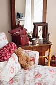 A teddybear on a floral-patterned sofa