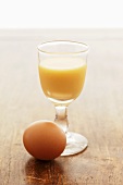 Advocaat in glass, hen's egg beside it