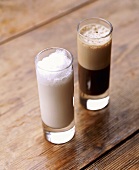 A glass of vanilla shake and a glass of coffee shake