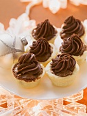 A plate of mini pies with chocolate cream