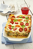 Vegetable lasagne topped with tomatoes and basil