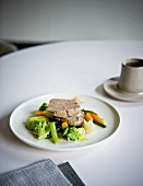 Cooked beef on a bed of vegetables