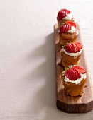 Friands with butterscotch sauce and strawberries