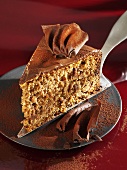A piece of gingerbread cake on cake server