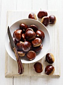 Chestnuts in and beside dish