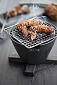 Sesame chicken wings on table grill