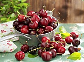 Fresh cherries in and beside pan