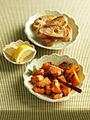 Fried pumpkin with garlic, toast, lemon wedges