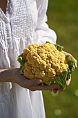 Woman holding yellow cauliflower