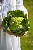 Woman holding green cauliflower