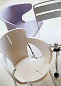 Group of different designer chairs in plastic and metal