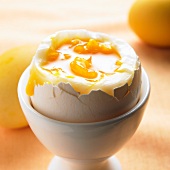 A soft boiled egg in an eggcup (close up)