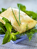 Fried tuna parcels on a bed of fresh herbs