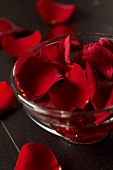 Red rose petals in a glass bowl