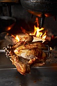 A grilled chicken on a spit