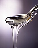 Glucose syrup dripping from a spoon