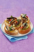 Toasted slices of baguette topped with smoked sprats