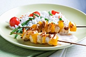 Marinated chicken kebabs with pepper and rice