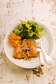 Oven-baked salmon with orange sauce and peanuts