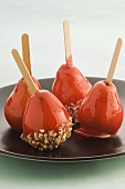Caramelised pears with nuts and desicated coconut on sticks