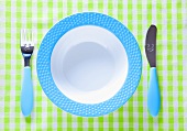 A child's place setting with a plate, knife and fork