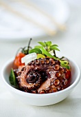 Grilled octopus with tomatoes and onions