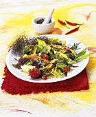 Mixed leaf salad with strawberries and edible flowers