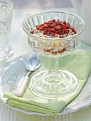 Muesli with goji berries in glass pedestal dish