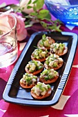 Herring tartare and peas on crackers