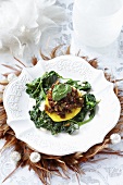 Dried tomato tartare on spinach for Easter