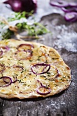 Pizza topped with red onions