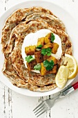 Roti (Indian flatbread) with potatoes and sour cream
