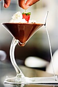 Chocolate mousse with cream and strawberry