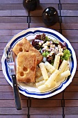 Breaded fried cheese with pasta and salad