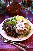Rabbit with white wine sauce, potatoes and salad leaves