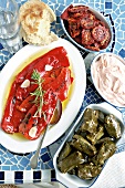 Dolmades, marinated peppers, dried tomatoes and taramasalata (Greece)