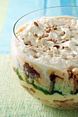 Trifle with sponge fingers, fruit, nuts and cream