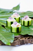 Pieces of cucumber stuffed with prawns and chive flowers