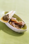 Anchovy paste and anchovies in a small bowl