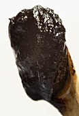 Tamarind paste on a wooden spoon