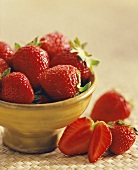 Strawberries in and beside a bowl
