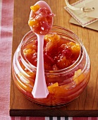 Rhubarb and orange jam on a spoon
