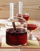 Home-made blackberry liqueur in carafe and glasses