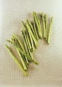 Green asparagus spears on linen background