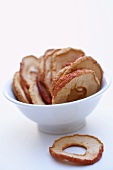 Dried unpeeled apple rings in a bowl